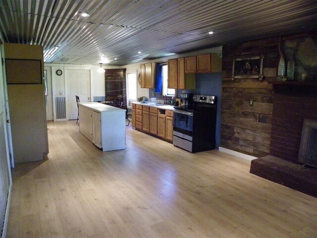 218 N 4150th Rd, Antlers, OK 74523 - kitchen featuring stainless steel electric range, a center island, light countertops, light wood finished floors, and brown cabinetry