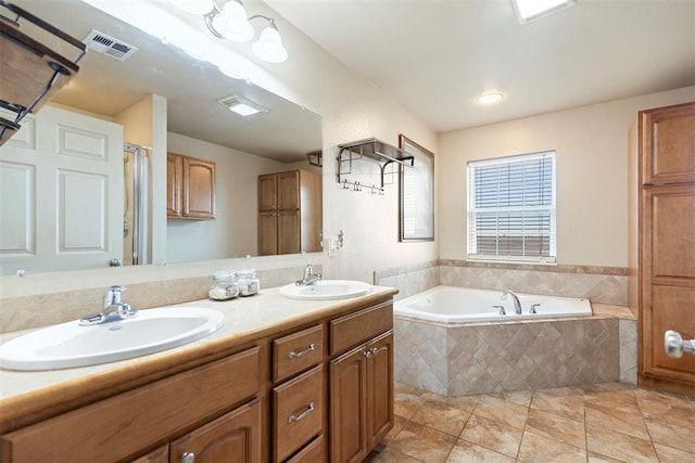 22950 E 1130th Rd, Bessie, OK 73622 - full bathroom featuring a garden tub, double vanity, tile patterned floors, and a shower with shower door
