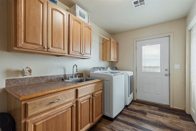 22950 E 1130th Rd, Bessie, OK 73622 - washroom with washing machine and clothes dryer, dark wood-style flooring, and cabinet space