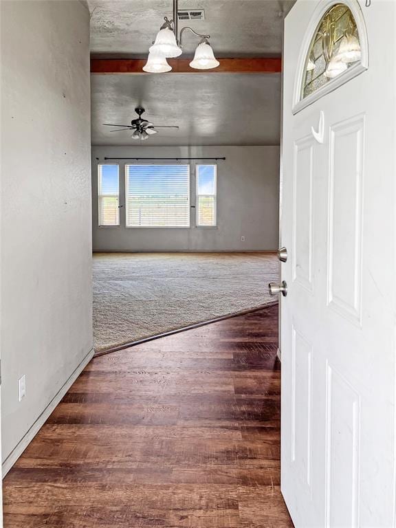 22950 E 1130th Rd, Bessie, OK 73622 - empty room with wood finished floors, a chandelier, and a ceiling fan