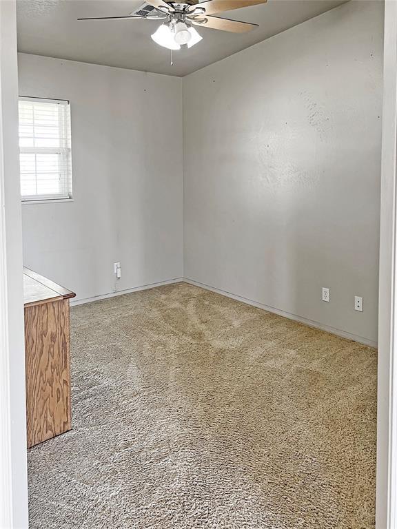 22950 E 1130th Rd, Bessie, OK 73622 - carpeted spare room featuring ceiling fan and baseboards
