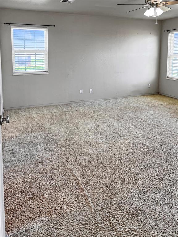 22950 E 1130th Rd, Bessie, OK 73622 - empty room featuring ceiling fan and carpet floors