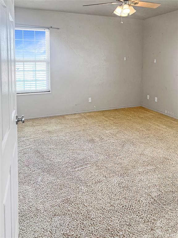 22950 E 1130th Rd, Bessie, OK 73622 - carpeted spare room featuring ceiling fan and baseboards