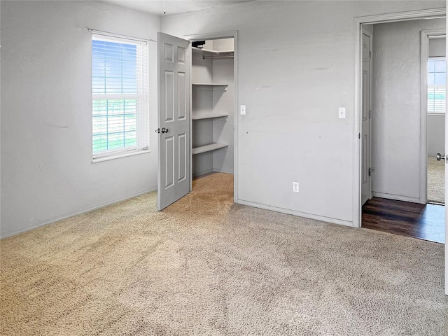 22950 E 1130th Rd, Bessie, OK 73622 - unfurnished bedroom featuring carpet floors and a spacious closet