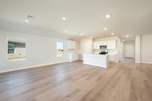 10324 NW 28th St, Yukon, OK 73099 - unfurnished living room with light wood-style flooring, recessed lighting, and baseboards