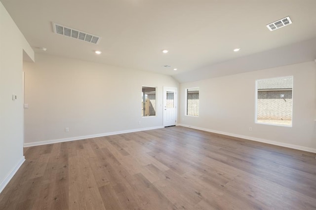 10324 NW 28th St, Yukon, OK 73099 - spare room with recessed lighting, baseboards, wood finished floors, and lofted ceiling