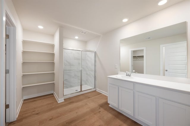 10324 NW 28th St, Yukon, OK 73099 - bathroom with a shower stall, a spacious closet, wood finished floors, vanity, and baseboards