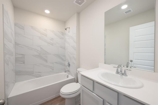 10324 NW 28th St, Yukon, OK 73099 - bathroom featuring toilet, wood finished floors, vanity, bathing tub / shower combination, and recessed lighting