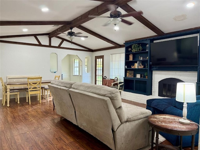 living area with ceiling fan, dark wood-type flooring, arched walkways, a fireplace, and recessed lighting