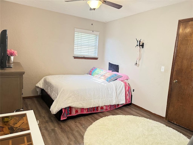 bedroom with wood finished floors, baseboards, and ceiling fan