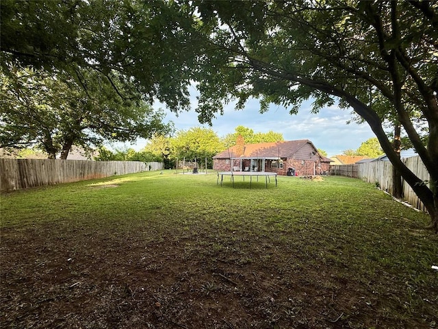 view of yard with a trampoline