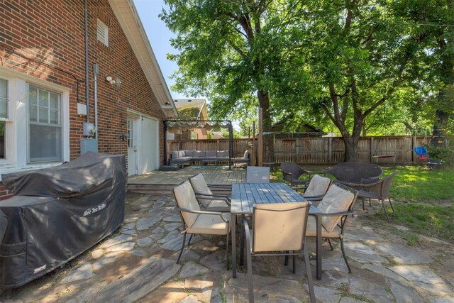 2534 NW 19th St, Oklahoma City, OK 73107 - fenced backyard with an outdoor living space, outdoor dining area, a patio, and area for grilling