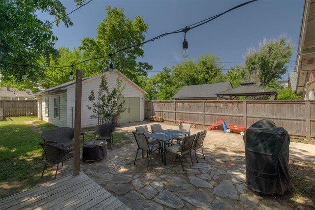 2534 NW 19th St, Oklahoma City, OK 73107 - view of patio featuring a gazebo, an outbuilding, a grill, and outdoor dining area