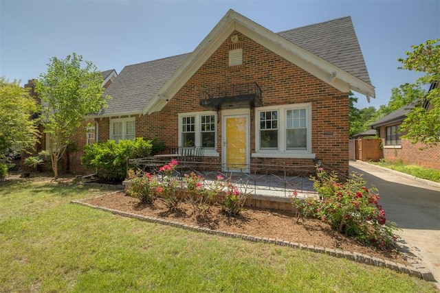 2534 NW 19th St, Oklahoma City, OK 73107 - view of front facade with brick siding, a front yard, and roof with shingles