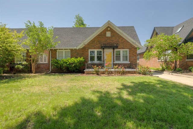 2534 NW 19th St, Oklahoma City, OK 73107 - view of front of house featuring a front yard and brick siding