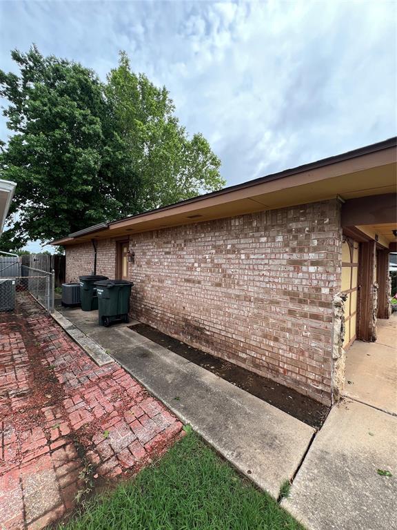 4125 Overland Dr, Del City, OK 73115 - view of property exterior featuring brick siding and fence