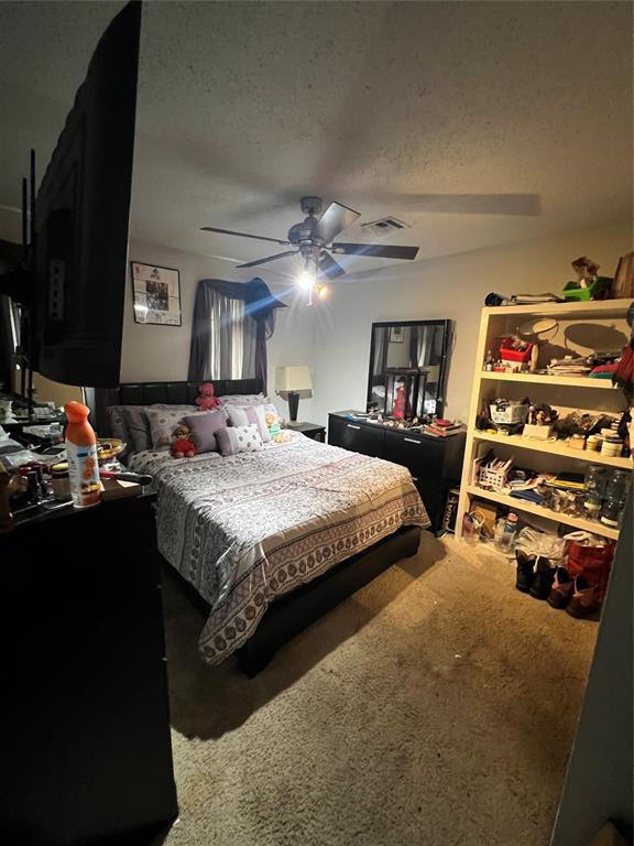 4125 Overland Dr, Del City, OK 73115 - bedroom featuring carpet flooring, a textured ceiling, and ceiling fan