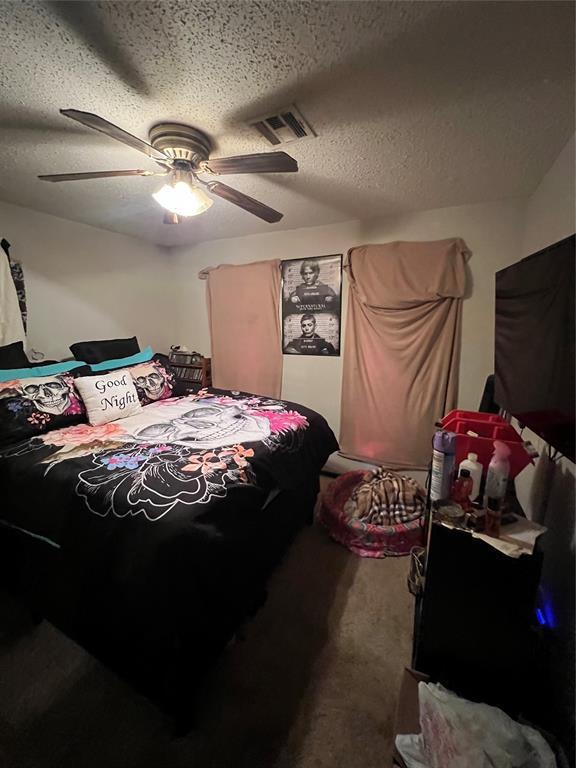 4125 Overland Dr, Del City, OK 73115 - bedroom with a textured ceiling and a ceiling fan