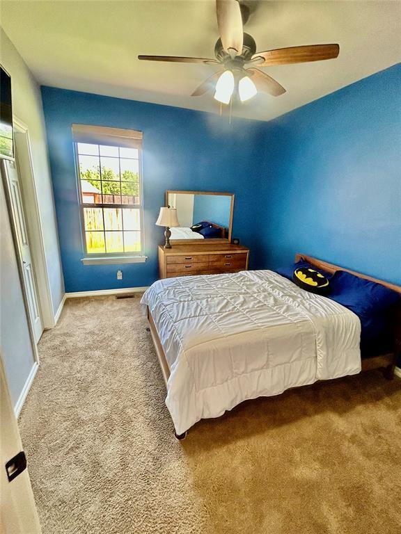 9817 Horseshoe Rd, Oklahoma City, OK 73162 - bedroom with carpet flooring, baseboards, and ceiling fan