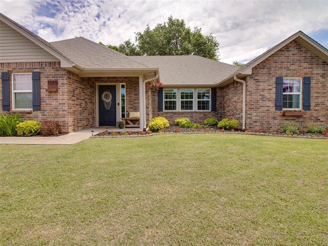 1015 N 3rd Ave, Stroud, OK 74079 - ranch-style home with brick siding, a front lawn, and a shingled roof