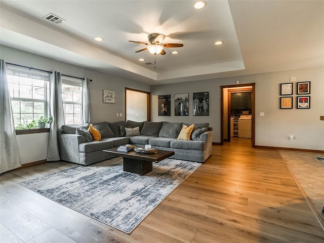 1015 N 3rd Ave, Stroud, OK 74079 - living area with a tray ceiling, light wood finished floors, a ceiling fan, recessed lighting, and baseboards