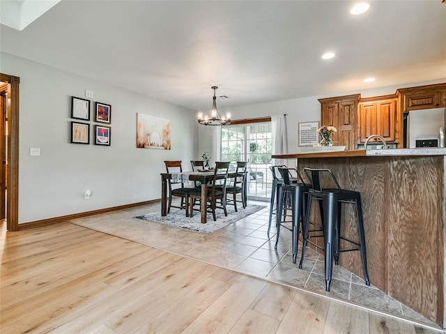 1015 N 3rd Ave, Stroud, OK 74079 - dining room with a chandelier, light wood-style flooring, recessed lighting, and baseboards