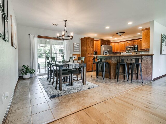 1015 N 3rd Ave, Stroud, OK 74079 - dining room with a chandelier, baseboards, recessed lighting, and light wood finished floors