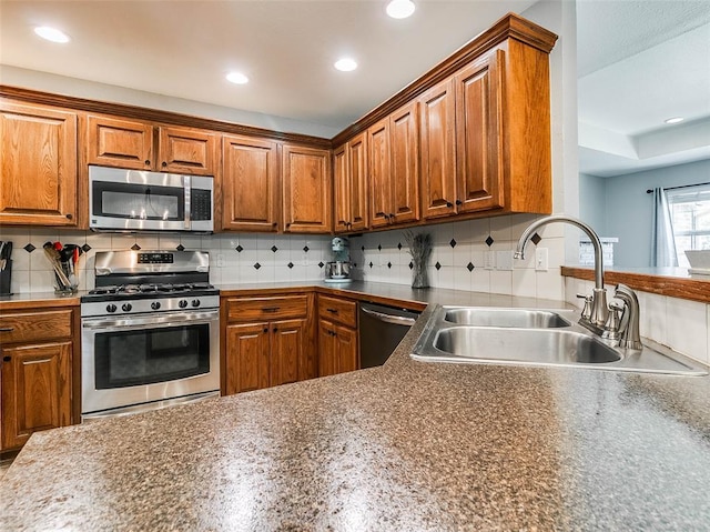 1015 N 3rd Ave, Stroud, OK 74079 - kitchen with stainless steel appliances, a sink, recessed lighting, brown cabinets, and backsplash