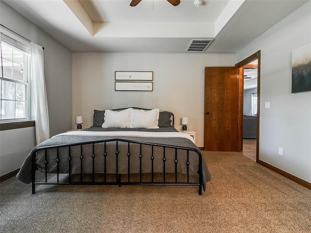 1015 N 3rd Ave, Stroud, OK 74079 - carpeted bedroom with a raised ceiling, ceiling fan, and baseboards