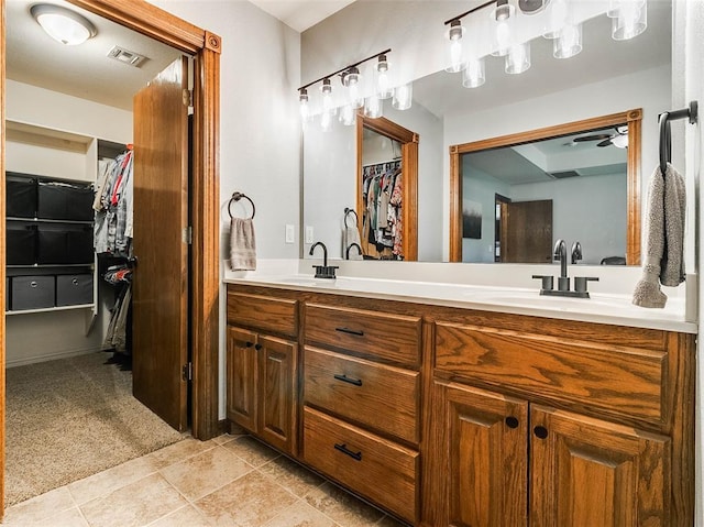 1015 N 3rd Ave, Stroud, OK 74079 - full bath with double vanity, a ceiling fan, a walk in closet, and tile patterned flooring