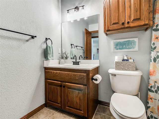 1015 N 3rd Ave, Stroud, OK 74079 - full bath with toilet, vanity, baseboards, tile patterned flooring, and a textured wall