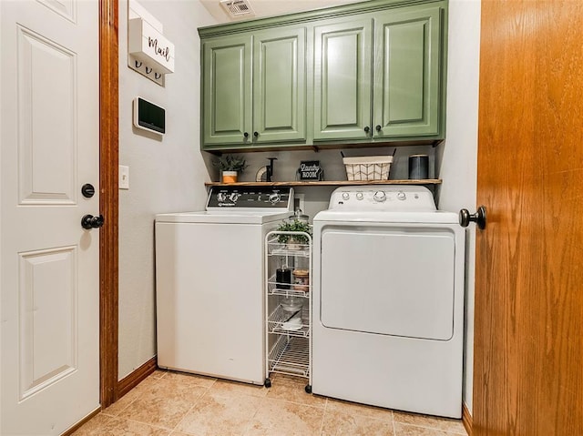 1015 N 3rd Ave, Stroud, OK 74079 - washroom with cabinet space, washer and dryer, baseboards, and light tile patterned flooring