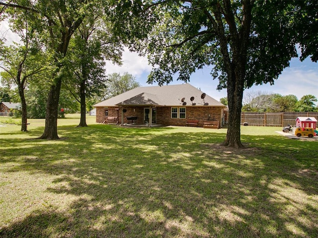 1015 N 3rd Ave, Stroud, OK 74079 - rear view of house featuring brick siding and a patio area