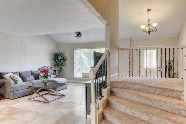 913 NE Dove Ln, Lawton, OK 73507 - living room with a ceiling fan, a chandelier, lofted ceiling, baseboards, and light tile patterned floors
