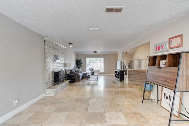 913 NE Dove Ln, Lawton, OK 73507 - living room with a textured ceiling, stairway, baseboards, and a fireplace