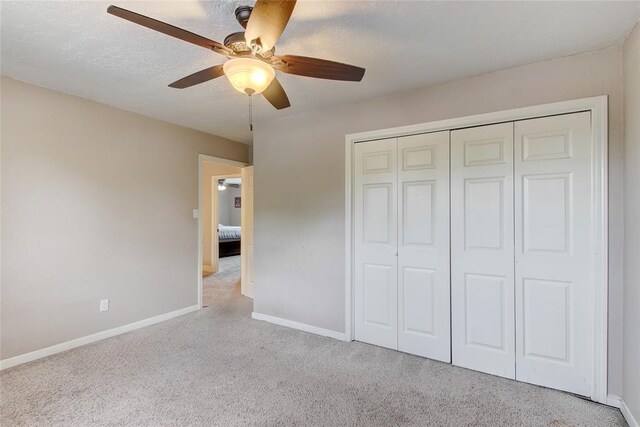 913 NE Dove Ln, Lawton, OK 73507 - unfurnished bedroom featuring carpet floors, baseboards, a closet, and ceiling fan