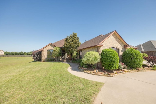 10681 NW 107th St, Yukon, OK 73099 - view of front of house with a front lawn and brick siding