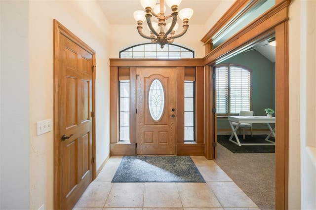 10681 NW 107th St, Yukon, OK 73099 - foyer entrance with a chandelier, light colored carpet, and baseboards
