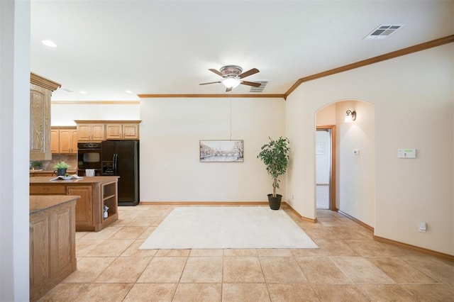 10681 NW 107th St, Yukon, OK 73099 - kitchen with arched walkways, a ceiling fan, black appliances, ornamental molding, and baseboards