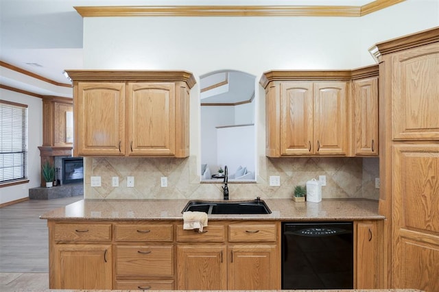 10681 NW 107th St, Yukon, OK 73099 - kitchen featuring black dishwasher, a sink, crown molding, light stone countertops, and backsplash
