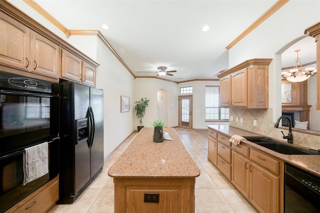 10681 NW 107th St, Yukon, OK 73099 - kitchen with black appliances, a sink, crown molding, a center island, and arched walkways