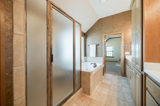 10681 NW 107th St, Yukon, OK 73099 - bathroom with vaulted ceiling, a bath, a shower stall, vanity, and tile patterned floors