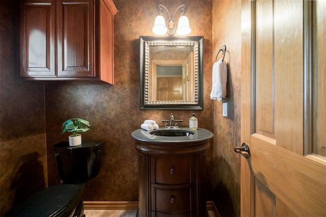 10681 NW 107th St, Yukon, OK 73099 - half bath with toilet, a chandelier, and vanity