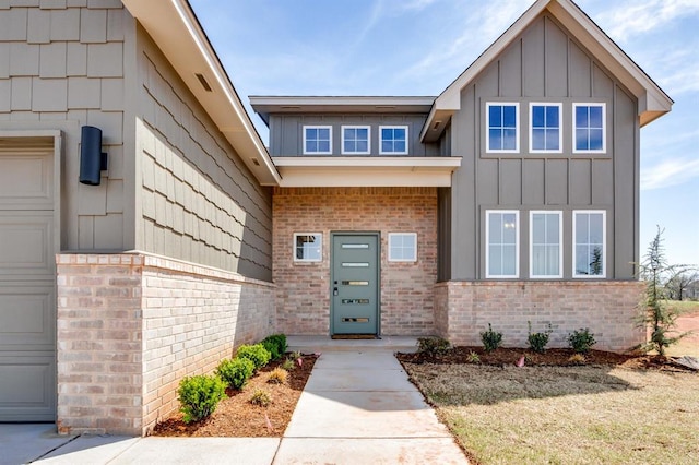 11616 NW 106th St, Yukon, OK 73099 - view of exterior entry with board and batten siding and brick siding