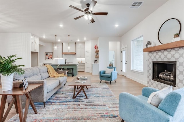 11616 NW 106th St, Yukon, OK 73099 - living room featuring light wood-style floors, a fireplace, ceiling fan, and recessed lighting