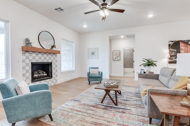 11616 NW 106th St, Yukon, OK 73099 - living room with light wood-style flooring, plenty of natural light, ceiling fan, a fireplace, and recessed lighting
