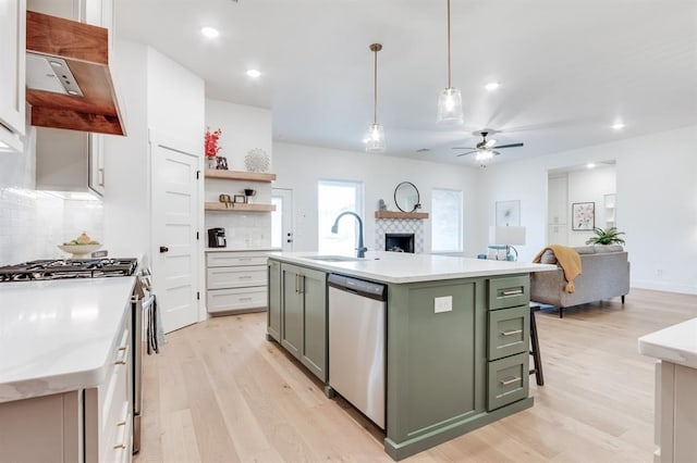 11616 NW 106th St, Yukon, OK 73099 - kitchen with green cabinets, stainless steel appliances, a sink, light wood-style flooring, and ceiling fan