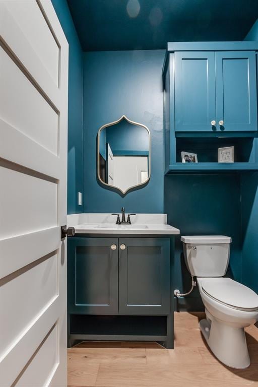 11616 NW 106th St, Yukon, OK 73099 - bathroom featuring toilet, wood finished floors, and vanity