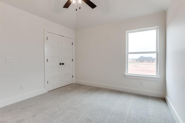 11616 NW 106th St, Yukon, OK 73099 - unfurnished bedroom featuring light carpet, baseboards, a ceiling fan, and a closet