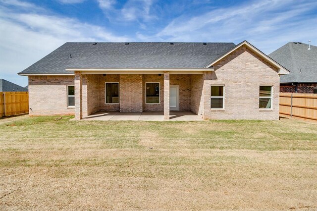 11616 NW 106th St, Yukon, OK 73099 - back of property featuring a patio area, a shingled roof, and brick siding